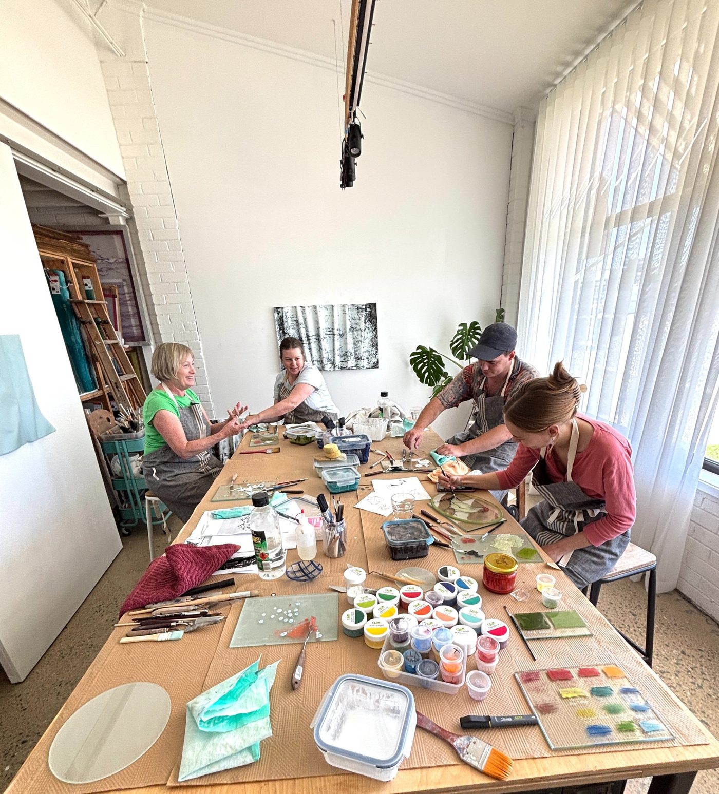 A group painting glass in the studio