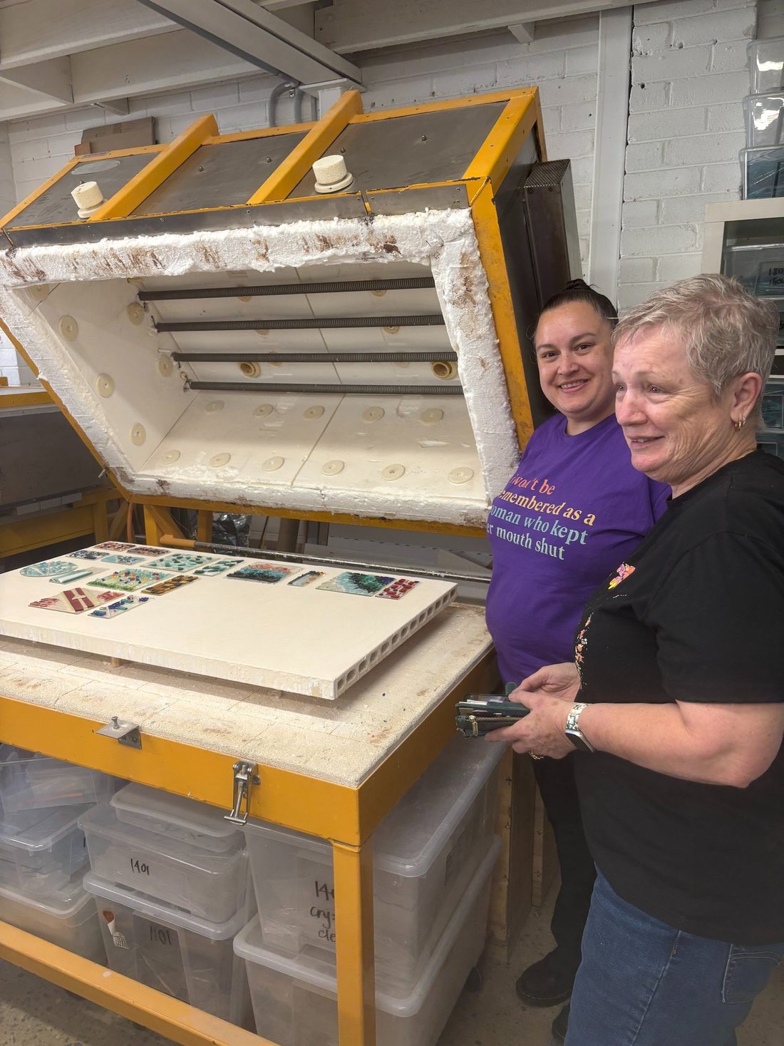Lisa with a student at the open kiln